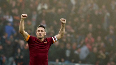 Roma's forward Francesco Totti celebrates after scoring during the Italian Serie A football match AS Roma vs Lazio on January 11, 2015 at the Olympic Stadium in Rome. AFP PHOTO / TIZIANA FABI (Photo credit should read TIZIANA FABI/AFP/Getty Images)